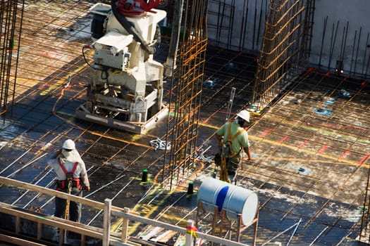 High angle view of two construction workers working at a construction site