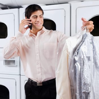 Man talking on a mobile phone in a laundromat