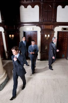 Four businessmen walking in a hotel lobby, Biltmore Hotel, Coral Gables, Florida, USA