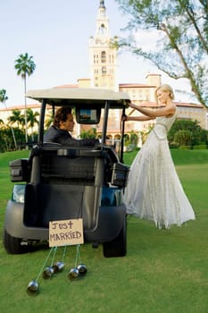 Newlywed couple in a golf cart, Biltmore Golf Course, Biltmore Hotel, Coral Gables, Florida, USA