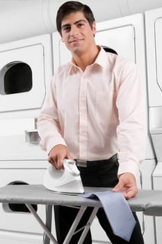Portrait of a man ironing a tie