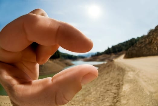 Close_up of a personŽs hand pretending to hold a lake, Shasta Lake, California, USA