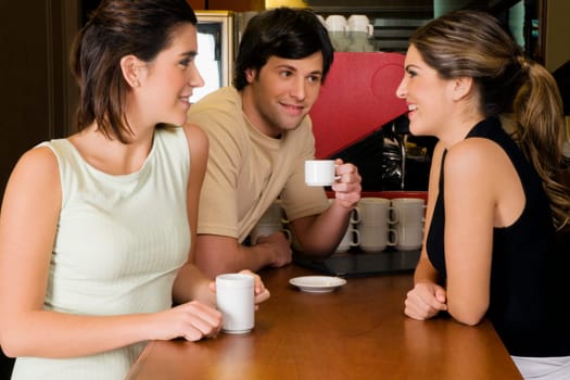 Waitress talking with two customers at a counter