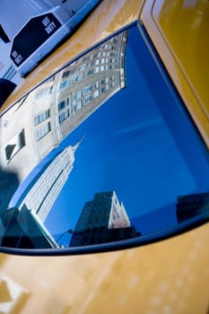 Reflection of buildings on the windshield of a yellow taxi, Empire State Building, Manhattan, New York City, New York State, USA