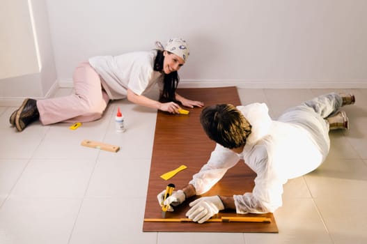 High angle view of a couple marking on a wood panel