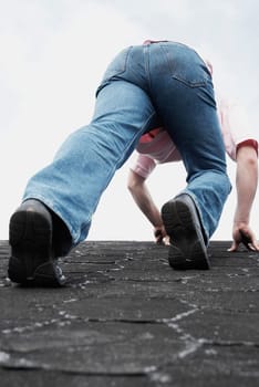 Low angle view of a young man climbing on a wall