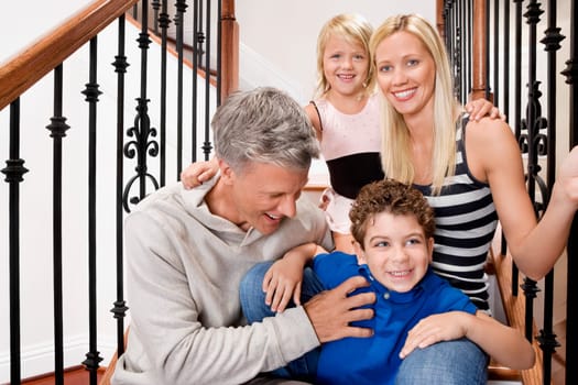 Portrait of a family smiling on a staircase