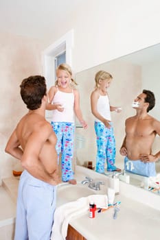 Girl playing with her father in the bathroom
