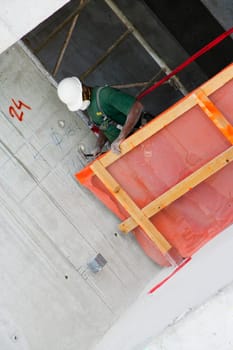 Construction worker making a wooden frame at a construction site