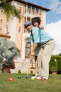 Couple playing croquet in a hotel lawn, Biltmore Hotel, Coral Gables, Florida, USA