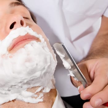Man getting shaved in a salon