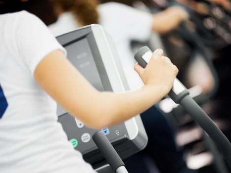 Mid section view of a person exercising on a treadmill