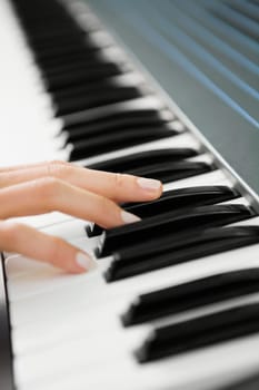 Close_up of a personŽs hand playing a piano