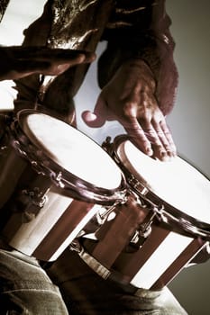 Close_up of a man playing a bongo