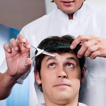 Man receiving a haircut in a salon