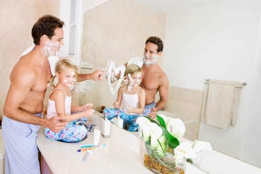 Girl playing with her father in the bathroom