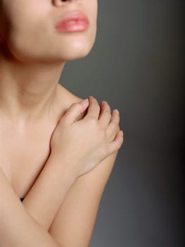 Close_up of a young woman with her arms crossed