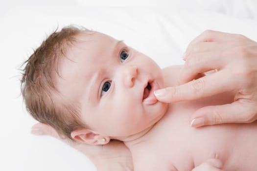 Close_up of a womanŽs finger touching her babyŽs lips