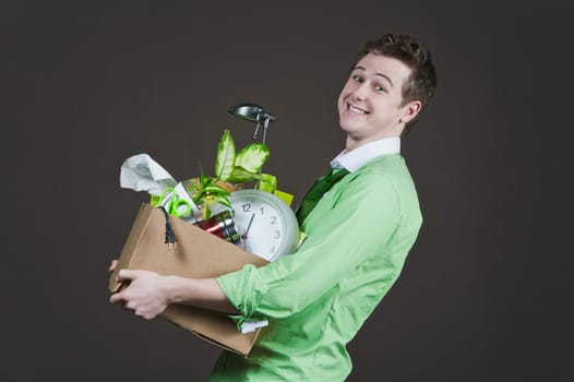 Businessman holding his belongings and smiling