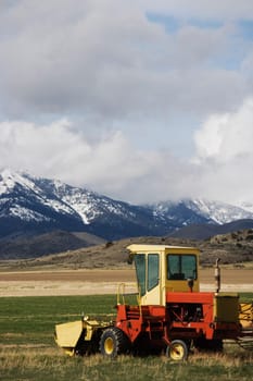 Tractor on a grassy field, Montana, USA