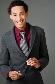 Portrait of a businessman holding his eyeglasses and smiling
