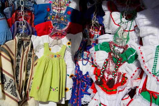 Close_up of traditional Mexican dresses at a market stall, Olvera Street, Los Angeles, California, USA