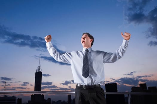 Businessman shouting with his arms outstretched