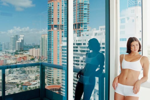 Young woman leaning against a railing in a balcony