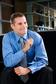 Young man sitting and smiling