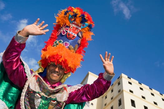 Low angle view of a mid adult man in traditional clothing and smiling