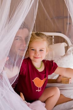 Baby girl with her mother in the bedroom