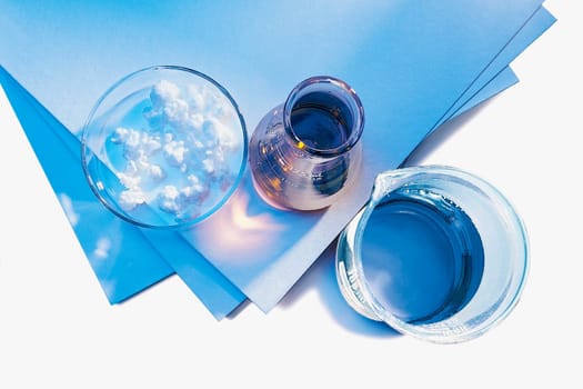 High angle view of a pitcher of water and a bowl of cream with sheets of paper