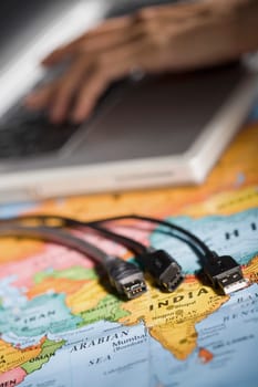 Close_up of computer cables on a world map