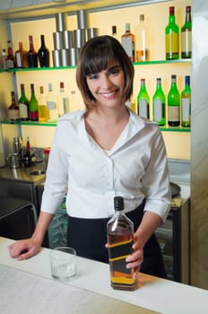 Portrait of a bartender standing in a bar and smiling