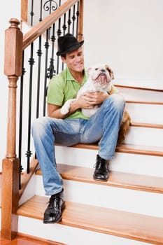 Man sitting on a staircase and carrying his dog