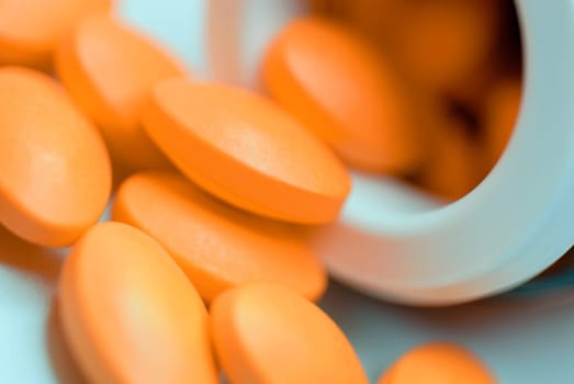 Close_up of pills spilling out from a pill bottle