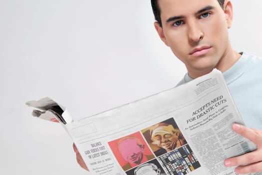 Close_up of a man reading a newspaper