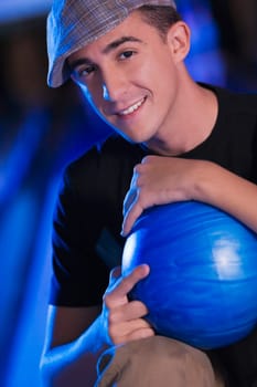 Portrait of a young man holding a bowling ball