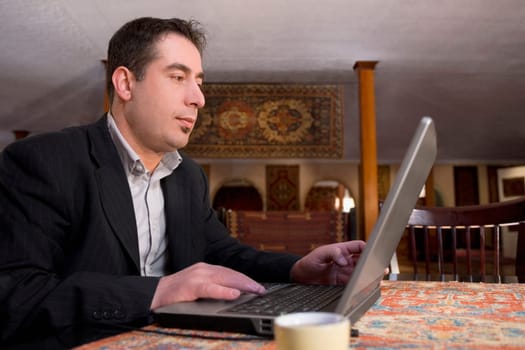 Businessman working on a laptop in a restaurant