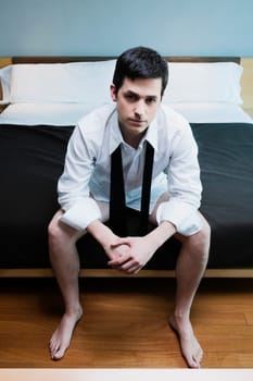 Businessman sitting on the bed and thinking