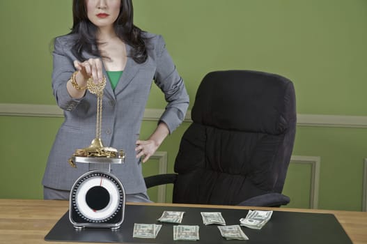 Businesswoman weighing gold jewelry