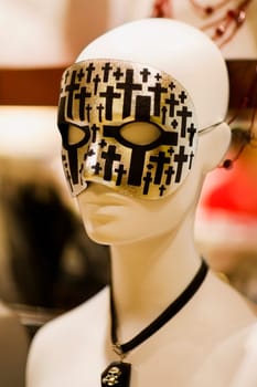 Close_up of a mannequin wearing a masquerade mask