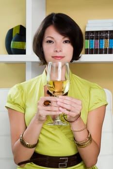 Portrait of a young woman holding a glass of wine