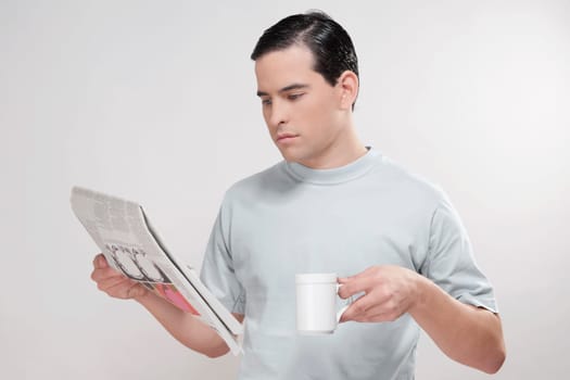 Close_up of a man reading a newspaper