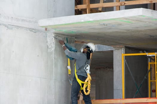 Side view of a construction worker working inside a building