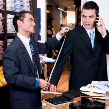 Tailor taking measurement of a businessman