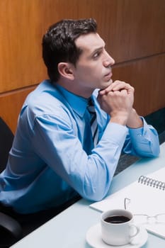 Businessman sitting in an office chair and thinking