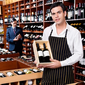 Sales clerk showing a crate of wine bottles