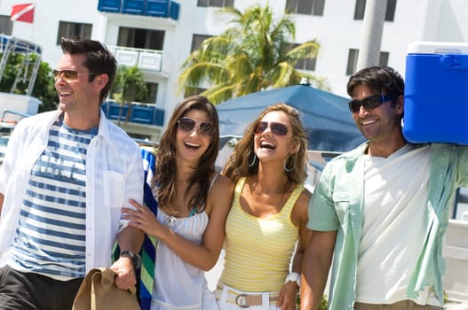 Two couples walking together and smiling