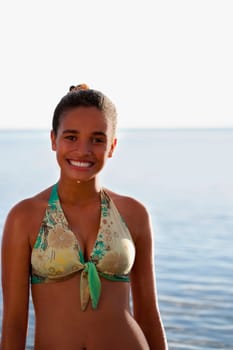 Portrait of a teenage girl smiling on the beach